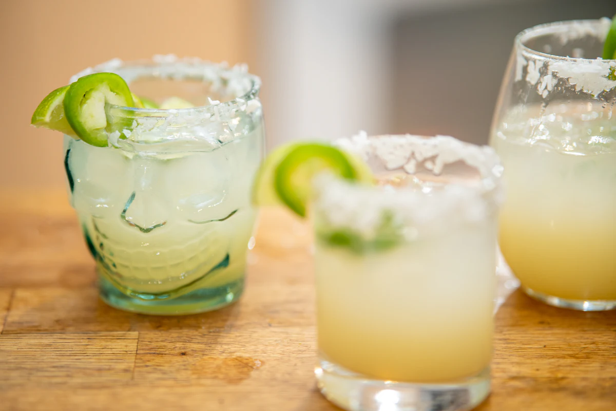Margaritas with salted rims and lime wedges