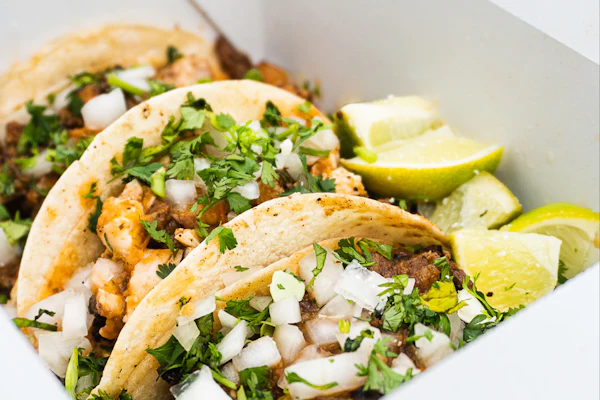 Street-style tacos topped with onion and coriander
